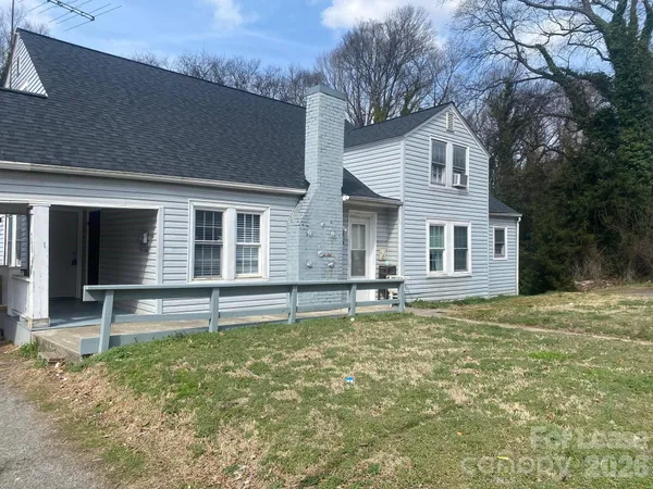 a front view of a house with a garden and yard