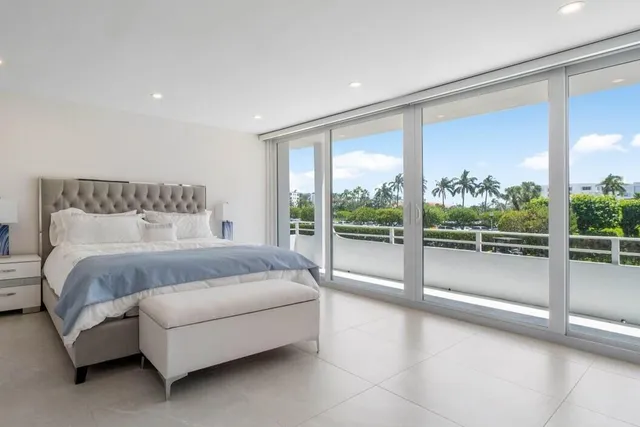 a spacious bedroom with a large bed and a large window