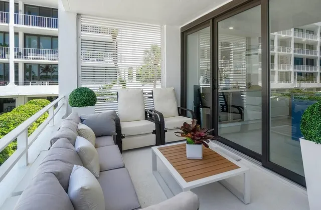 a living room with furniture and a floor to ceiling window