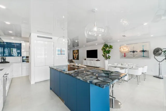 a kitchen with stainless steel appliances granite countertop a sink and a refrigerator