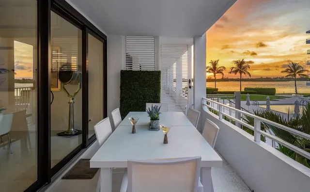 a view of a balcony dining table and chairs