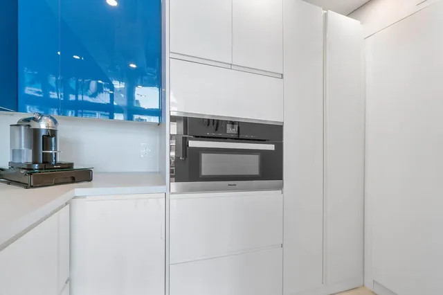a kitchen with stainless steel appliances granite countertop a sink and a stove