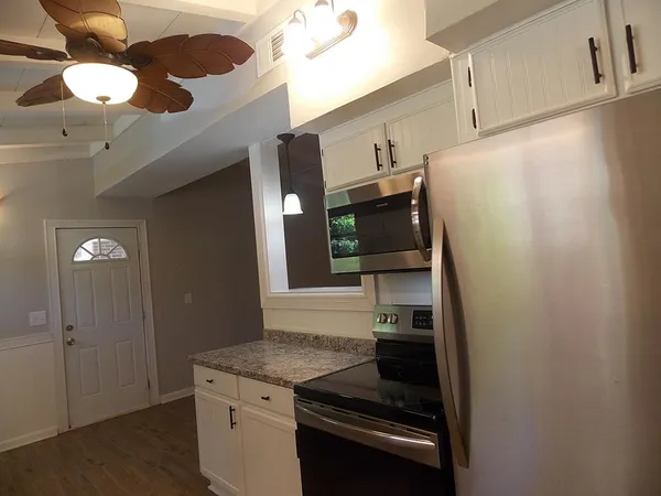 a kitchen with cabinets and stainless steel appliances