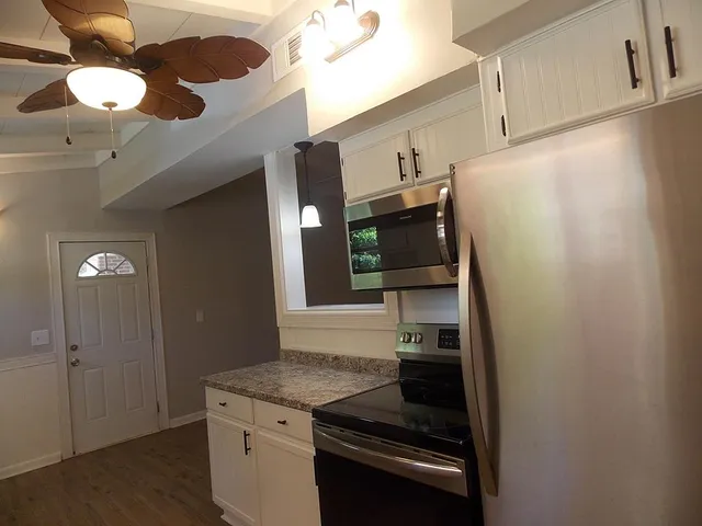 a kitchen with cabinets and stainless steel appliances