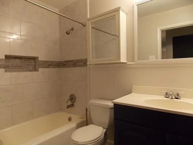 a bathroom with a sink toilet a bathtub and shower