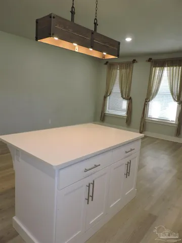 a kitchen with a sink a stove and a window
