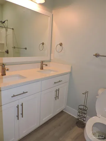 a bathroom with a toilet sink and mirror