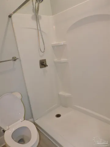 a bathroom with a toilet and shower