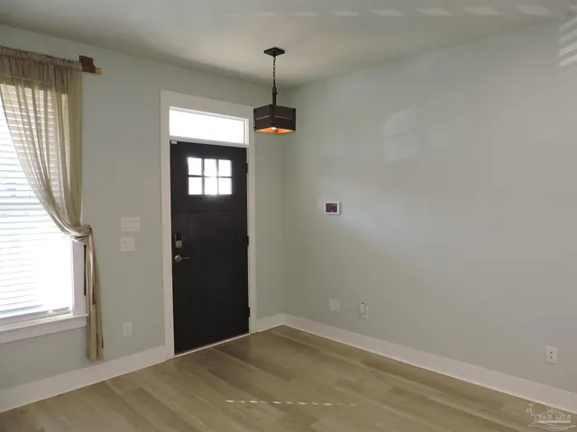 an empty room with windows and closet