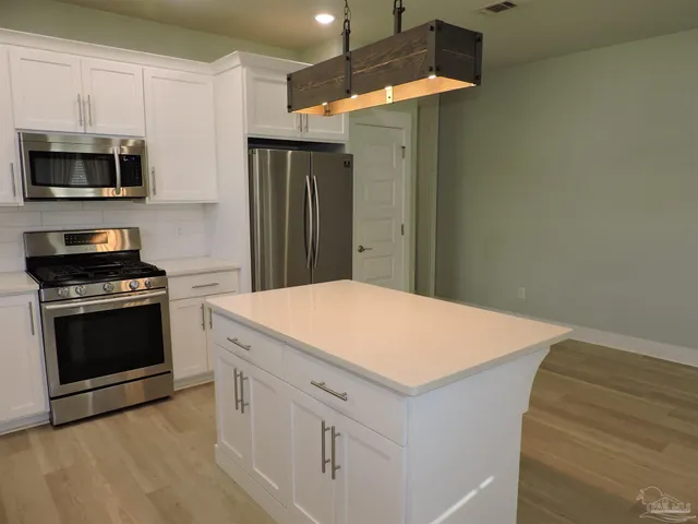 a kitchen with a stove and a microwave