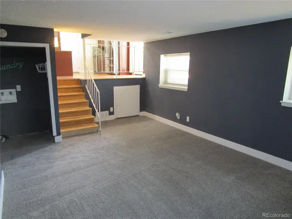 a view of an empty room with a fireplace