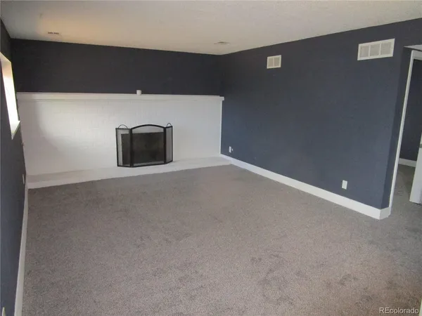 a view of an empty room with a fireplace
