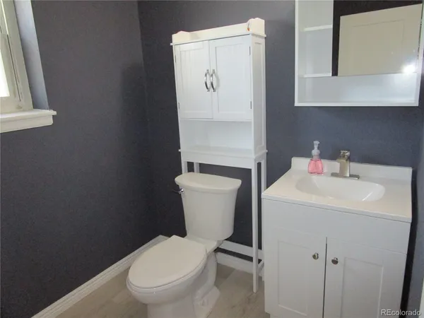 a white toilet sitting next to a bathroom sink