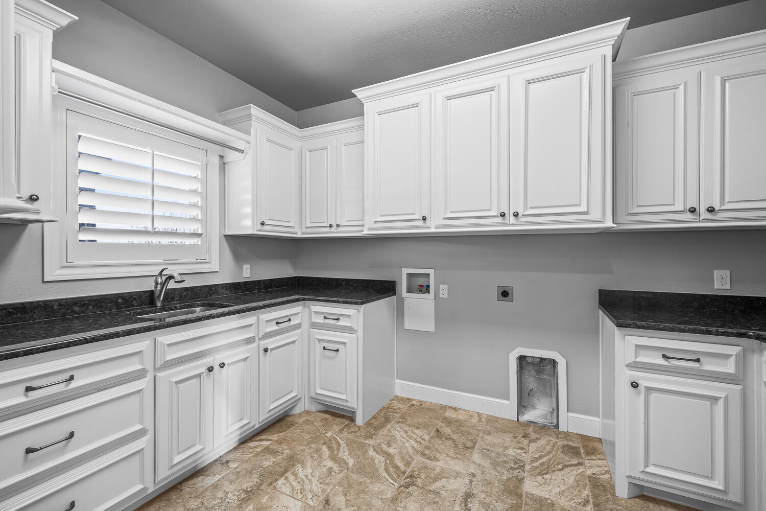 4509 103rd Street Lubbock, TX 79424 - Photo 23 of 94 a kitchen with granite countertop white cabinets and white appliances