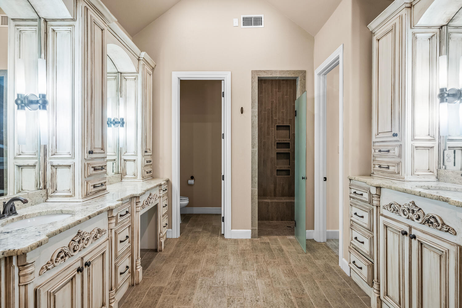 4509 103rd Street Lubbock, TX 79424 - Photo 29 of 94 a spacious bathroom with a double vanity sink a mirror and a shower