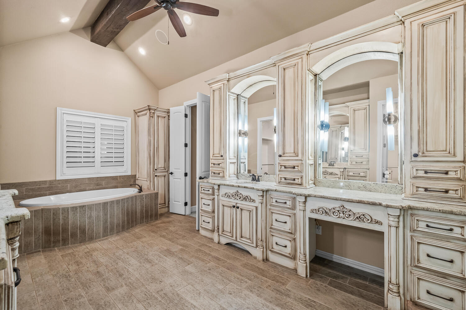 4509 103rd Street Lubbock, TX 79424 - Photo 31 of 94 a spacious bathroom with a granite countertop tub a double vanity sink a vanity and a large mirror