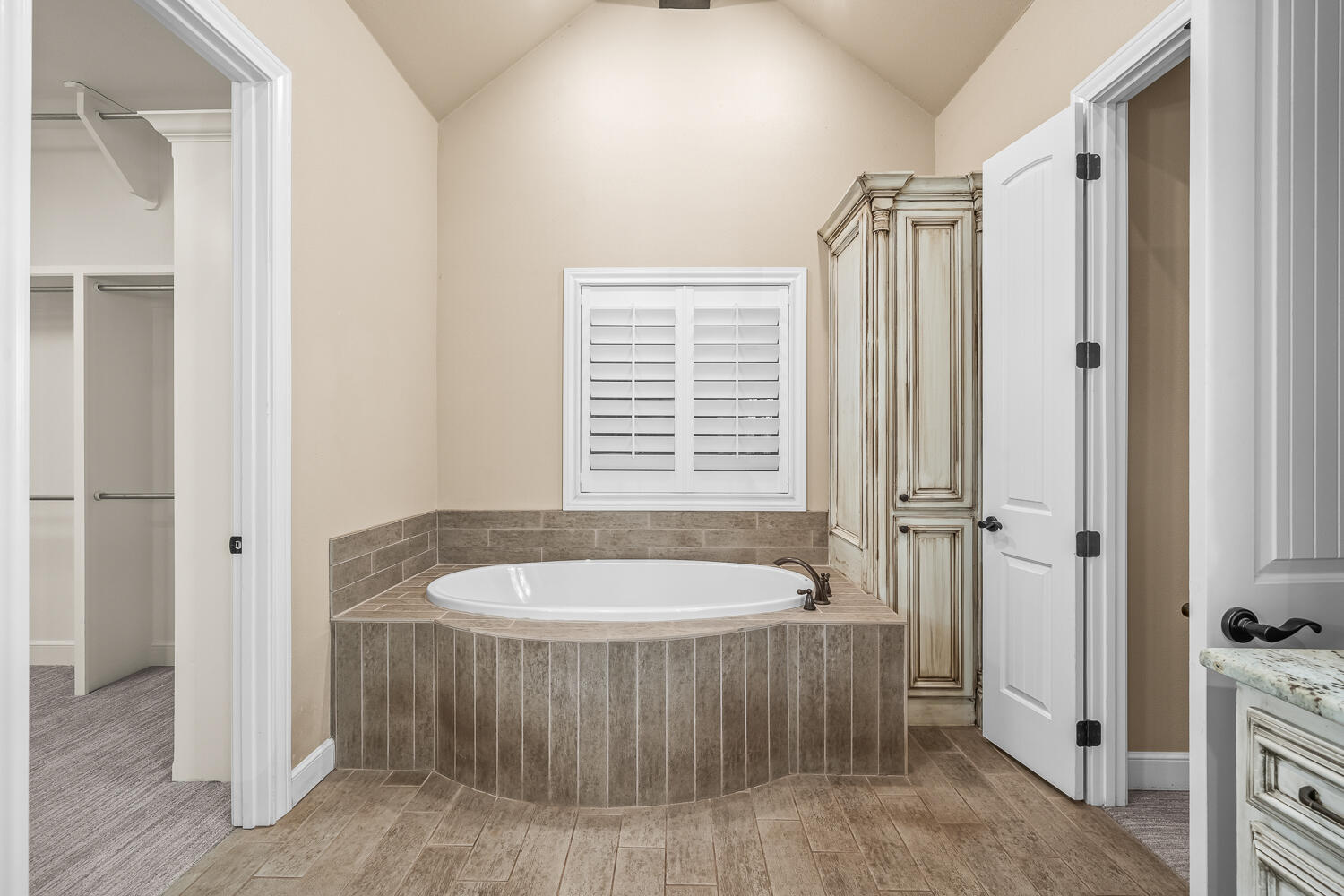 4509 103rd Street Lubbock, TX 79424 - Photo 33 of 94 a bathroom with a tub a sink and a window