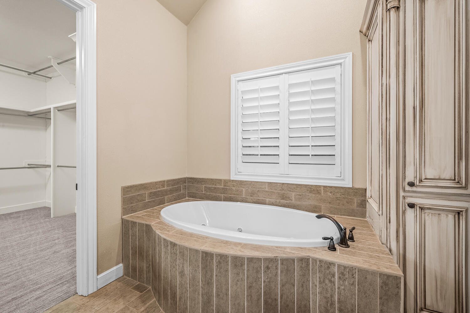 4509 103rd Street Lubbock, TX 79424 - Photo 34 of 94 a bathroom with a tub and a window