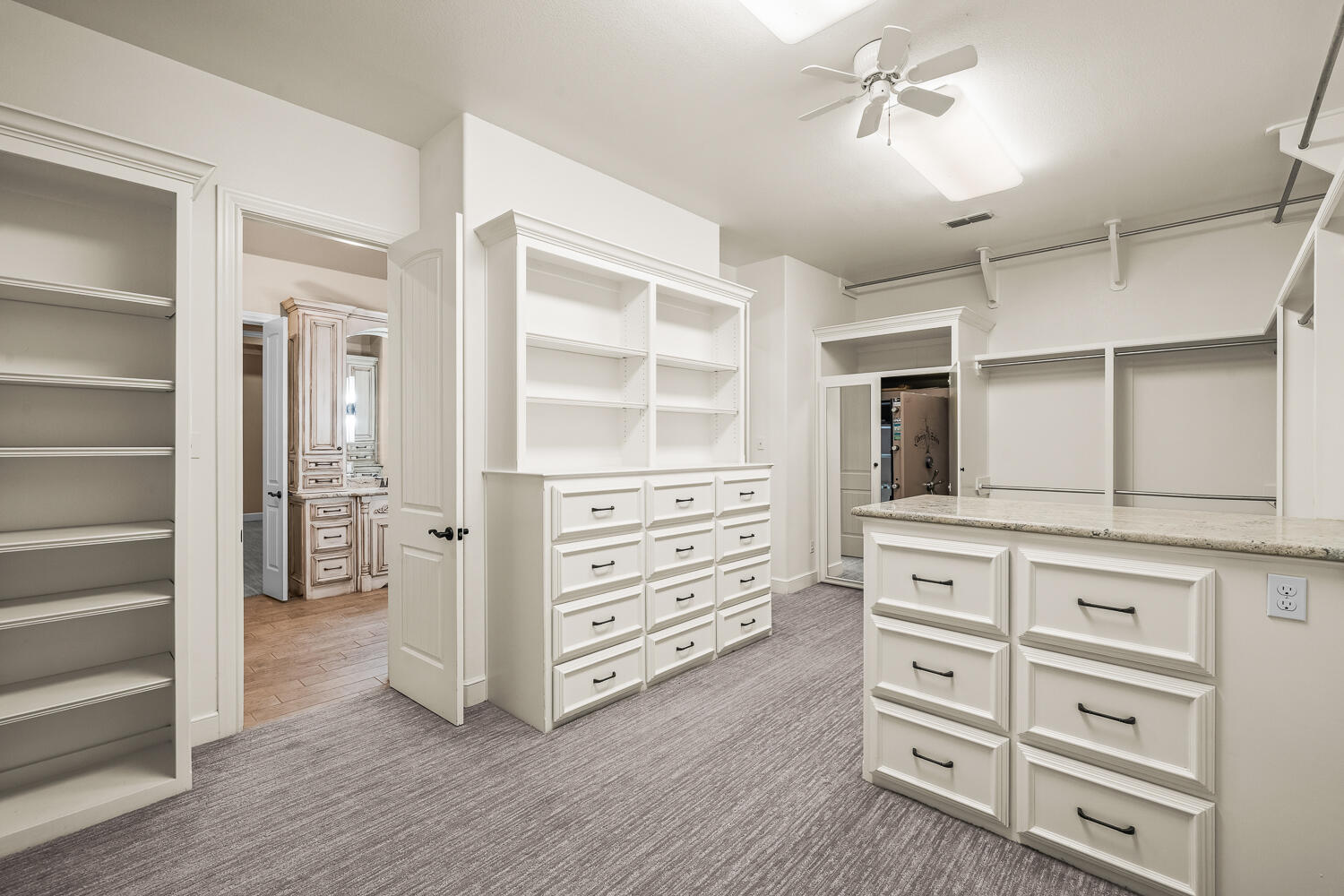 4509 103rd Street Lubbock, TX 79424 - Photo 37 of 94 a view of walk in closet and wooden cabinet
