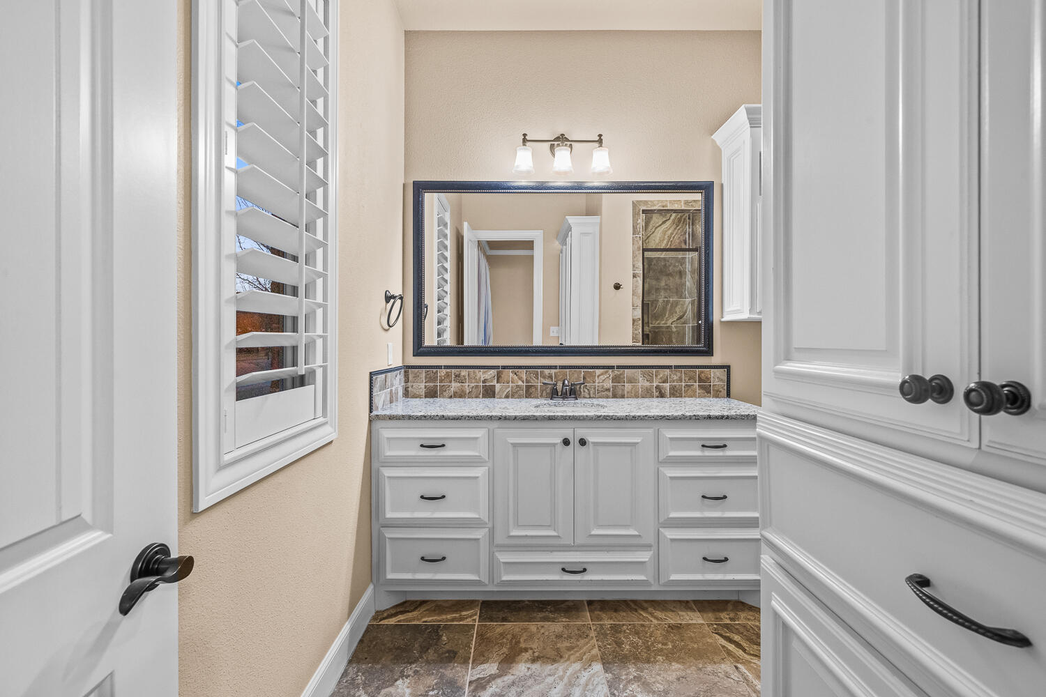 4509 103rd Street Lubbock, TX 79424 - Photo 68 of 94 a bathroom with a sink a vanity and a mirror
