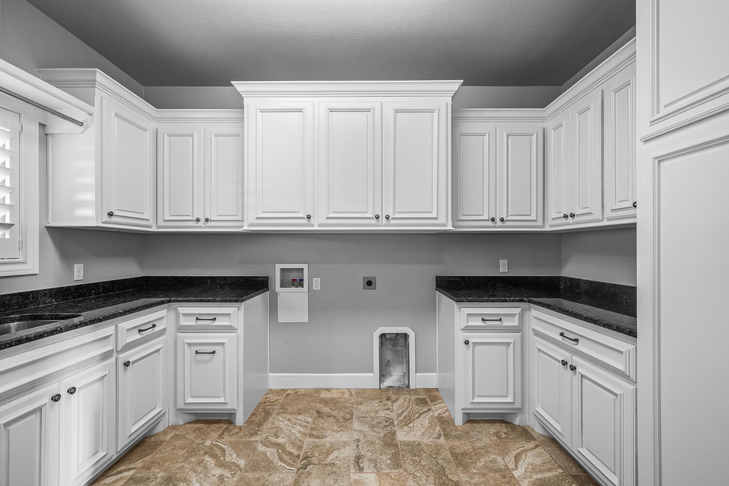 4509 103rd Street Lubbock, TX 79424 - Photo 72 of 94 a kitchen with granite countertop white cabinets and white appliances
