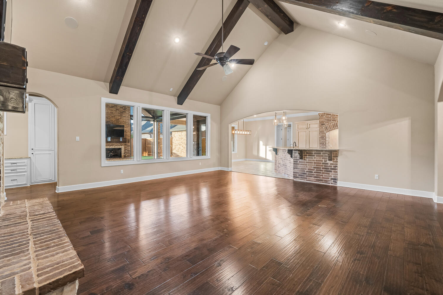 4509 103rd Street Lubbock, TX 79424 - Photo 10 of 94 a view of an empty room with wooden floor and a window