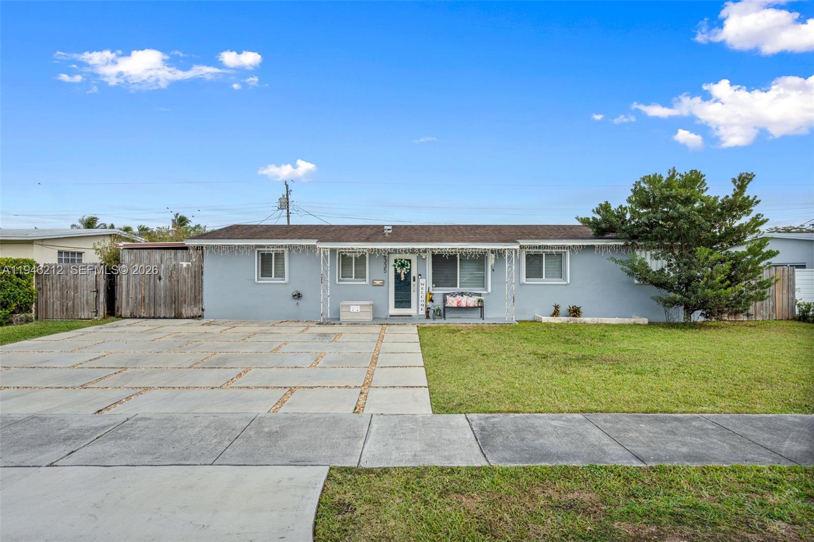 4335 Southwest 98th Court Miami, FL 33165 - Photo 1 of 38 a front view of a house with a yard and garage