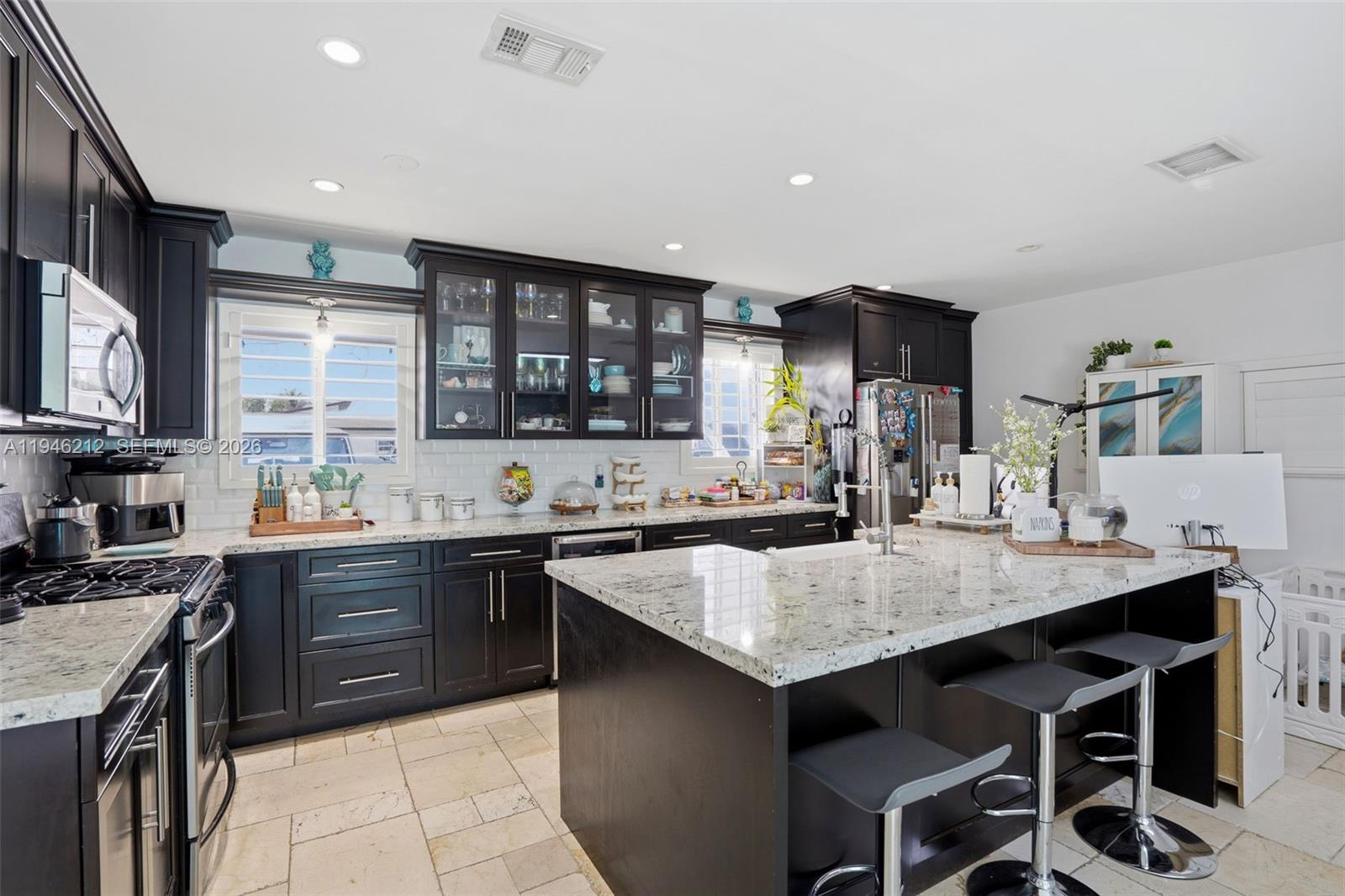 4335 Southwest 98th Court Miami, FL 33165 - Photo 13 of 38 a kitchen with granite countertop a sink and cabinets