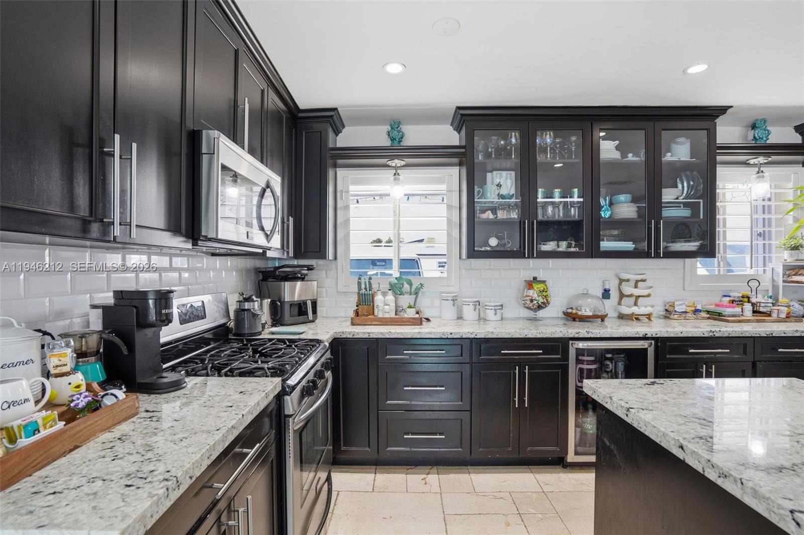 4335 Southwest 98th Court Miami, FL 33165 - Photo 17 of 38 a kitchen with stainless steel appliances granite countertop a sink stove and cabinets