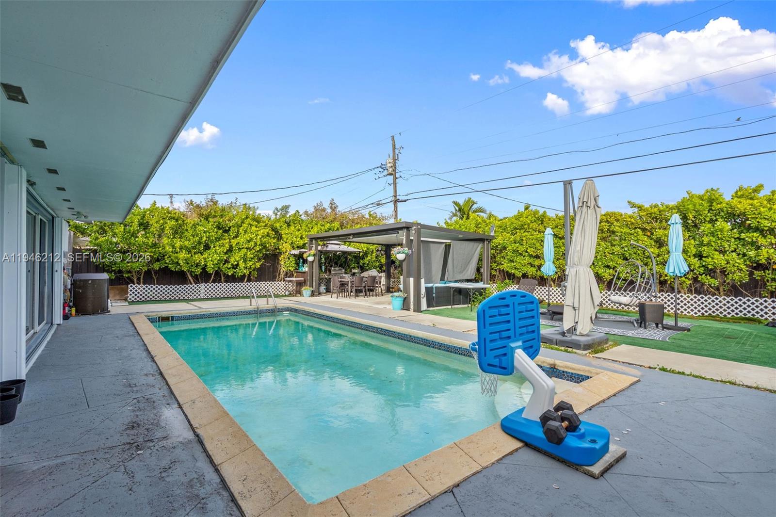 4335 Southwest 98th Court Miami, FL 33165 - Photo 33 of 38 a swimming pool with outdoor seating and yard