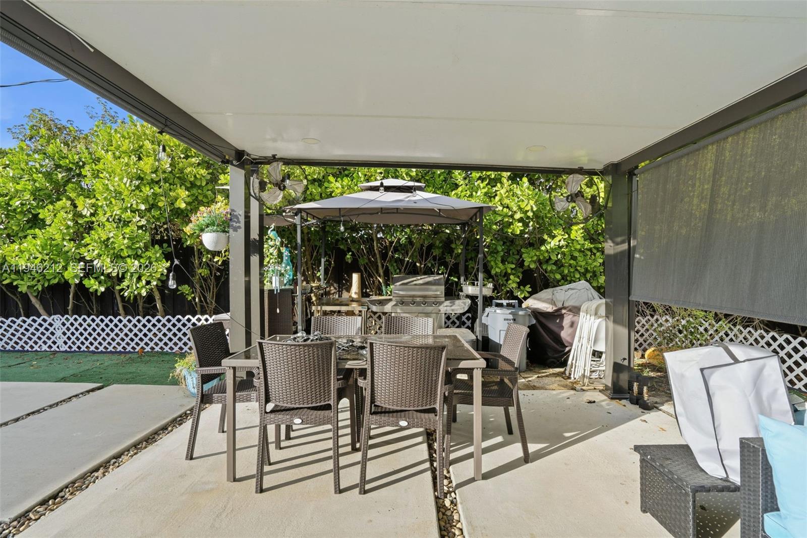 4335 Southwest 98th Court Miami, FL 33165 - Photo 37 of 38 a view of a patio with a table chairs and a backyard