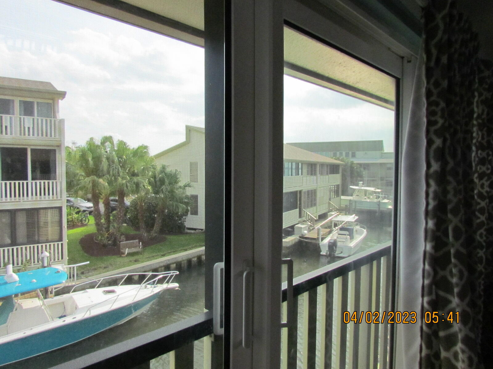 1456 Northeast Ocean Boulevard, Unit 2202 Stuart, FL 34996 - Photo 12 of 20 a view of a room with a large window and wooden floor