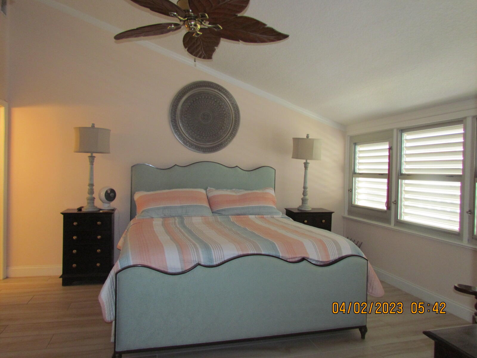 1456 Northeast Ocean Boulevard, Unit 2202 Stuart, FL 34996 - Photo 15 of 20 a bedroom with a bed and a chandelier