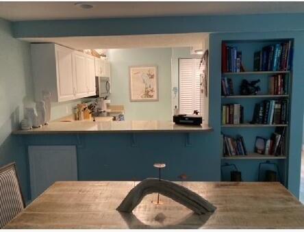 1456 Northeast Ocean Boulevard, Unit 2202 Stuart, FL 34996 - Photo 3 of 20 a kitchen with a refrigerator and a sink