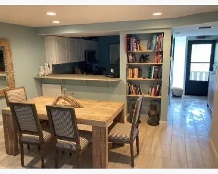 a dining room with furniture and a book shelf