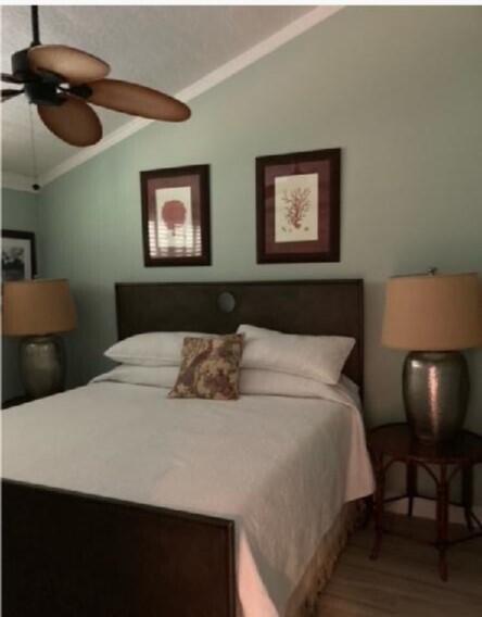 1456 Northeast Ocean Boulevard, Unit 2202 Stuart, FL 34996 - Photo 5 of 20 a bedroom with a bed and cabinets