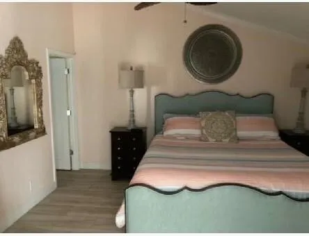 a bedroom with a bed and a mirror