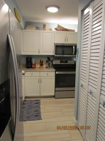a kitchen with stainless steel appliances a stove a sink and a refrigerator