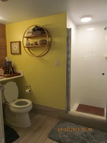 a bathroom with a toilet and a mirror