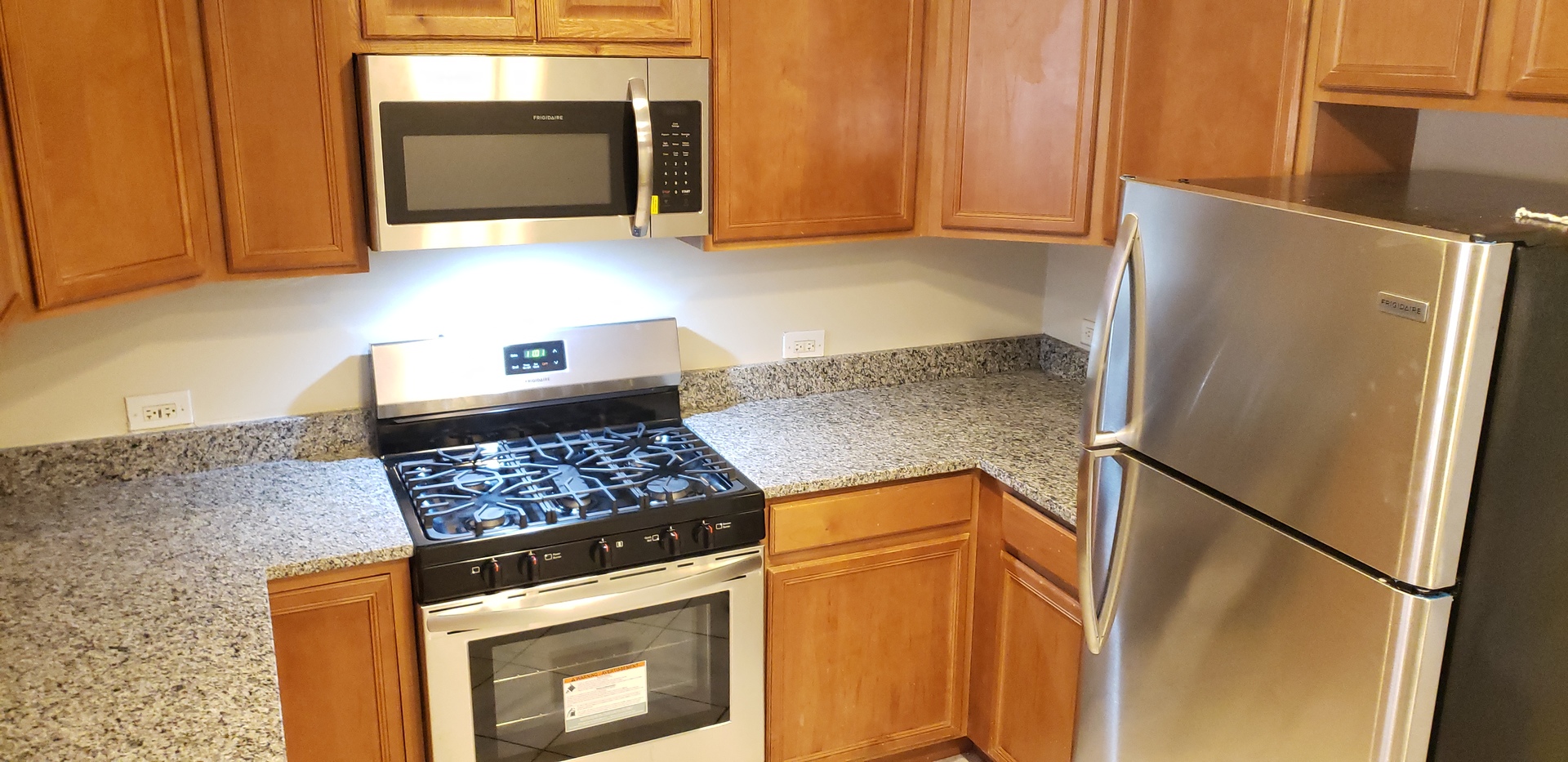 1906 Grove Avenue, Unit GARDEN Berwyn, IL 60402 - Photo 2 of 9 a kitchen with stainless steel appliances granite countertop a refrigerator stove and microwave
