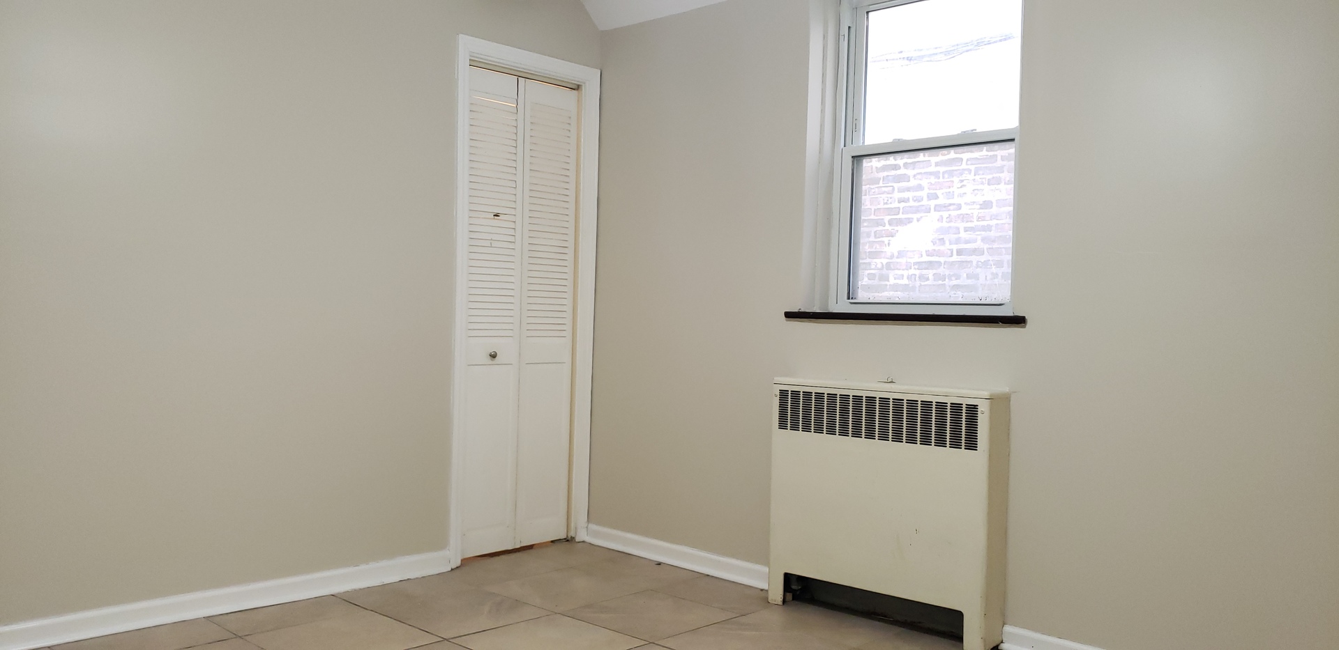 1906 Grove Avenue, Unit GARDEN Berwyn, IL 60402 - Photo 9 of 9 a room with a window and a dresser