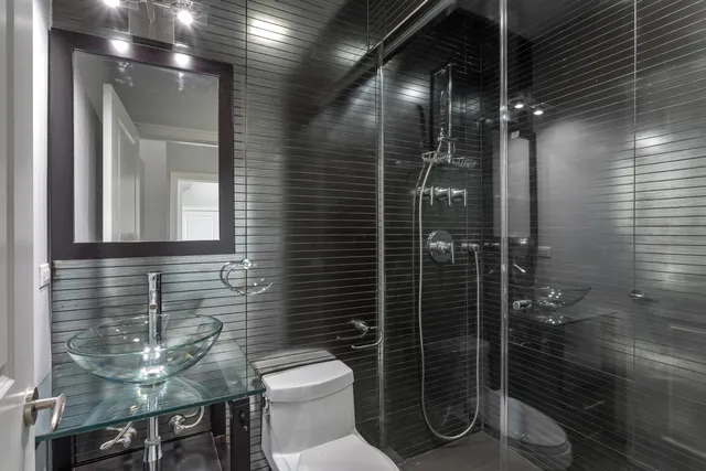 a bathroom with a toilet and a shower