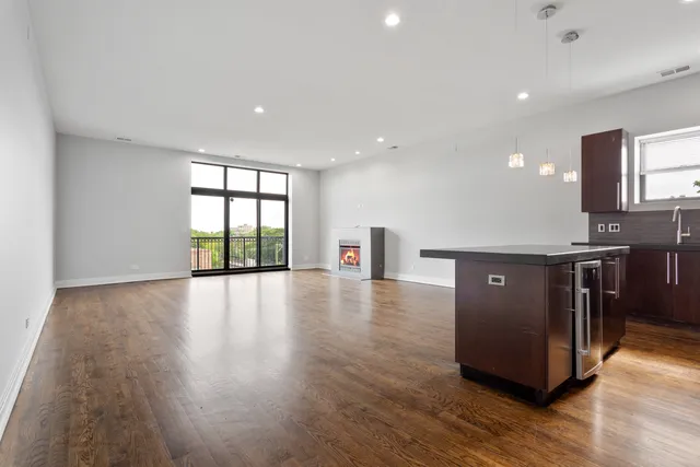 a view of a kitchen with a sink and a large window