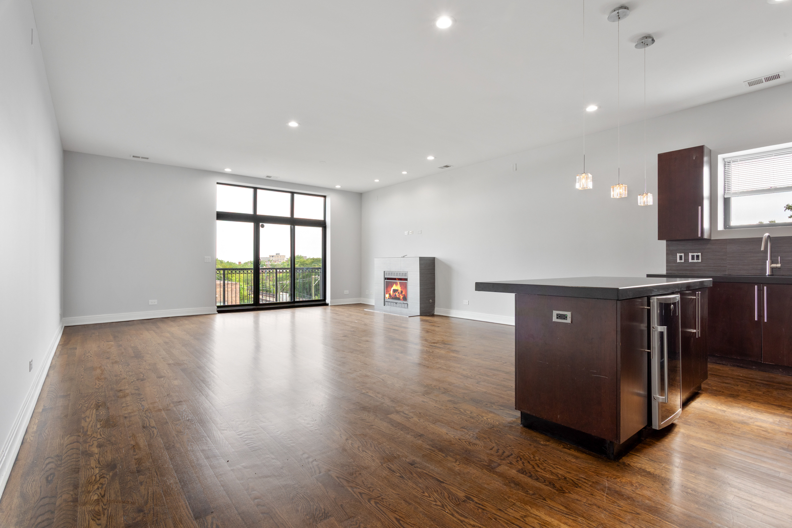 1412 West Morse Avenue, Unit 5D Chicago, IL 60626 - Photo 2 of 16 a view of a kitchen with a sink and a large window