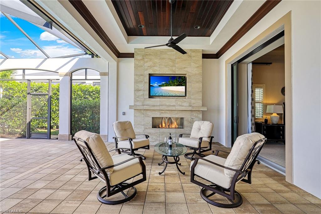 16459 Seneca Way Naples, FL 34110 - Photo 11 of 50 a outdoor space with patio couch and a fireplace