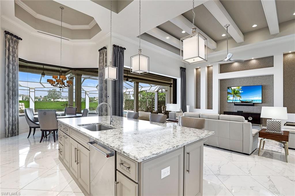 16459 Seneca Way Naples, FL 34110 - Photo 14 of 50 a large kitchen with kitchen island a large window in it