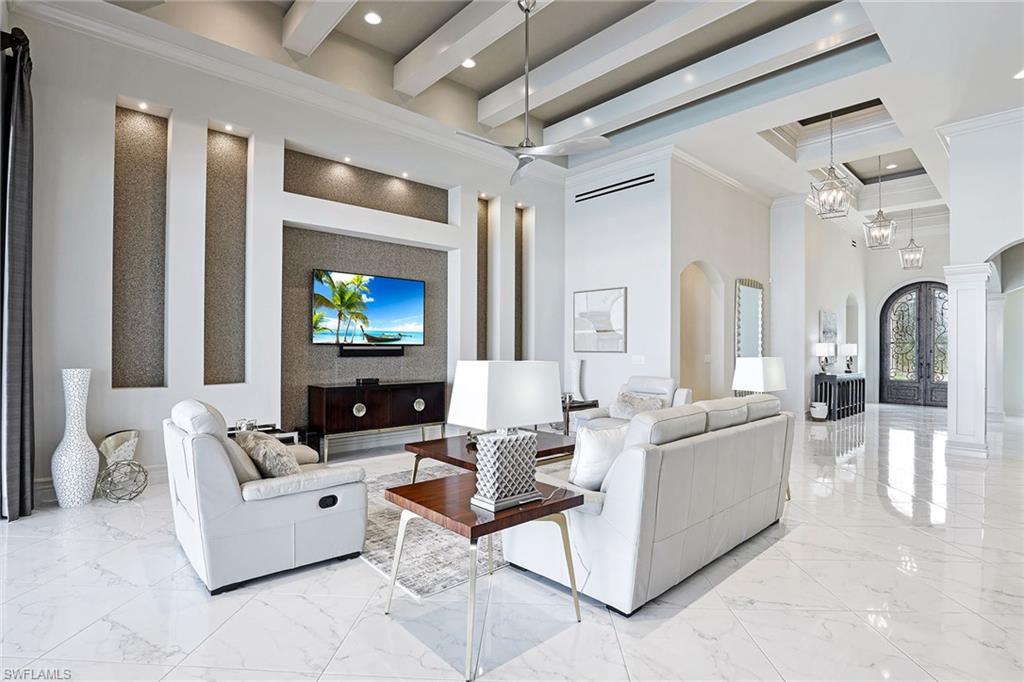 16459 Seneca Way Naples, FL 34110 - Photo 16 of 50 a living room with furniture and a flat screen tv