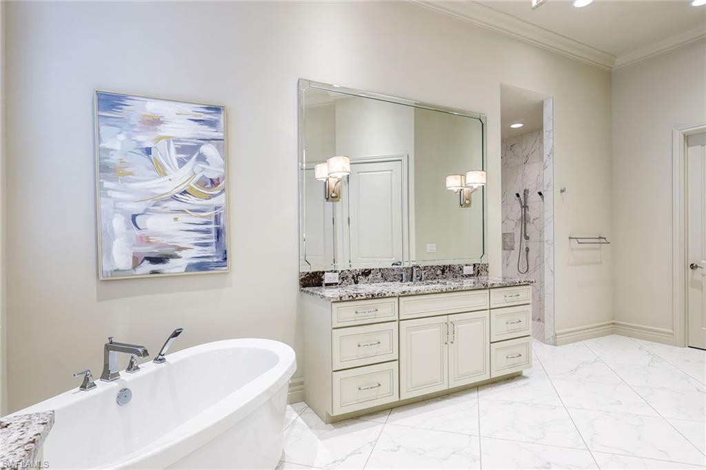 16459 Seneca Way Naples, FL 34110 - Photo 22 of 50 a bathroom with a double vanity sink mirror and double