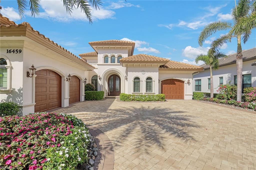 16459 Seneca Way Naples, FL 34110 - Photo 41 of 50 a front view of a house with a garden