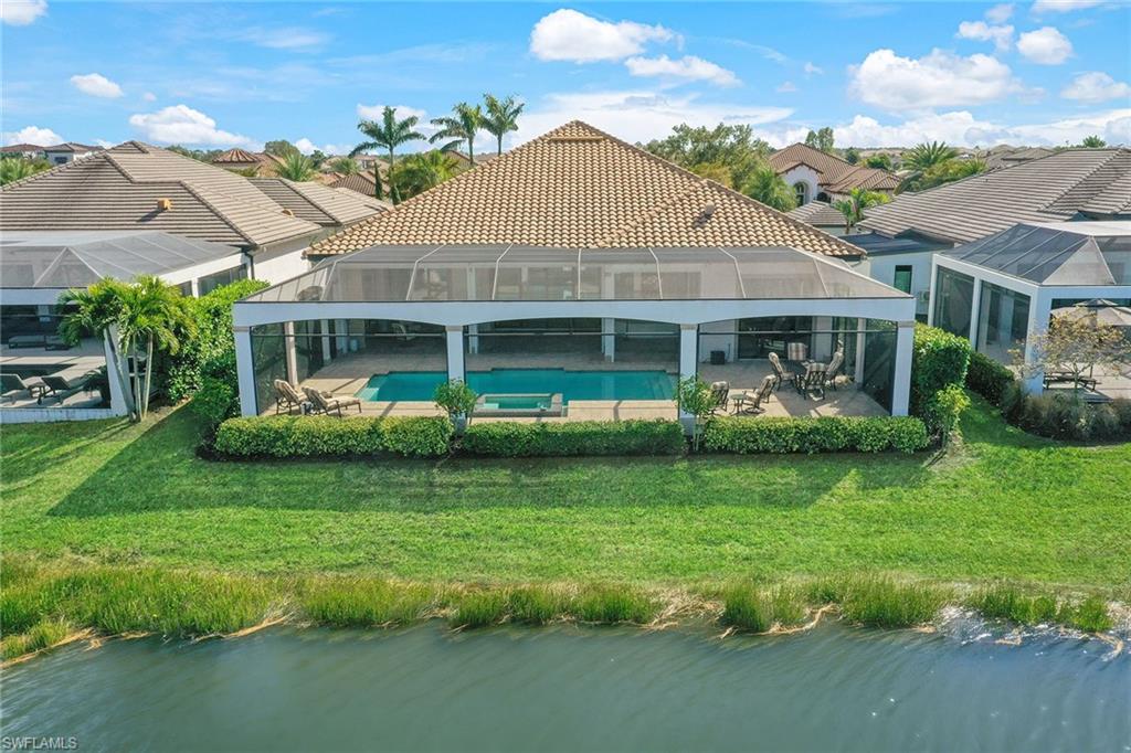 16459 Seneca Way Naples, FL 34110 - Photo 45 of 50 a front view of a house with a garden